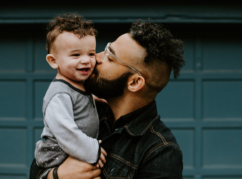 A young father caring for his son.